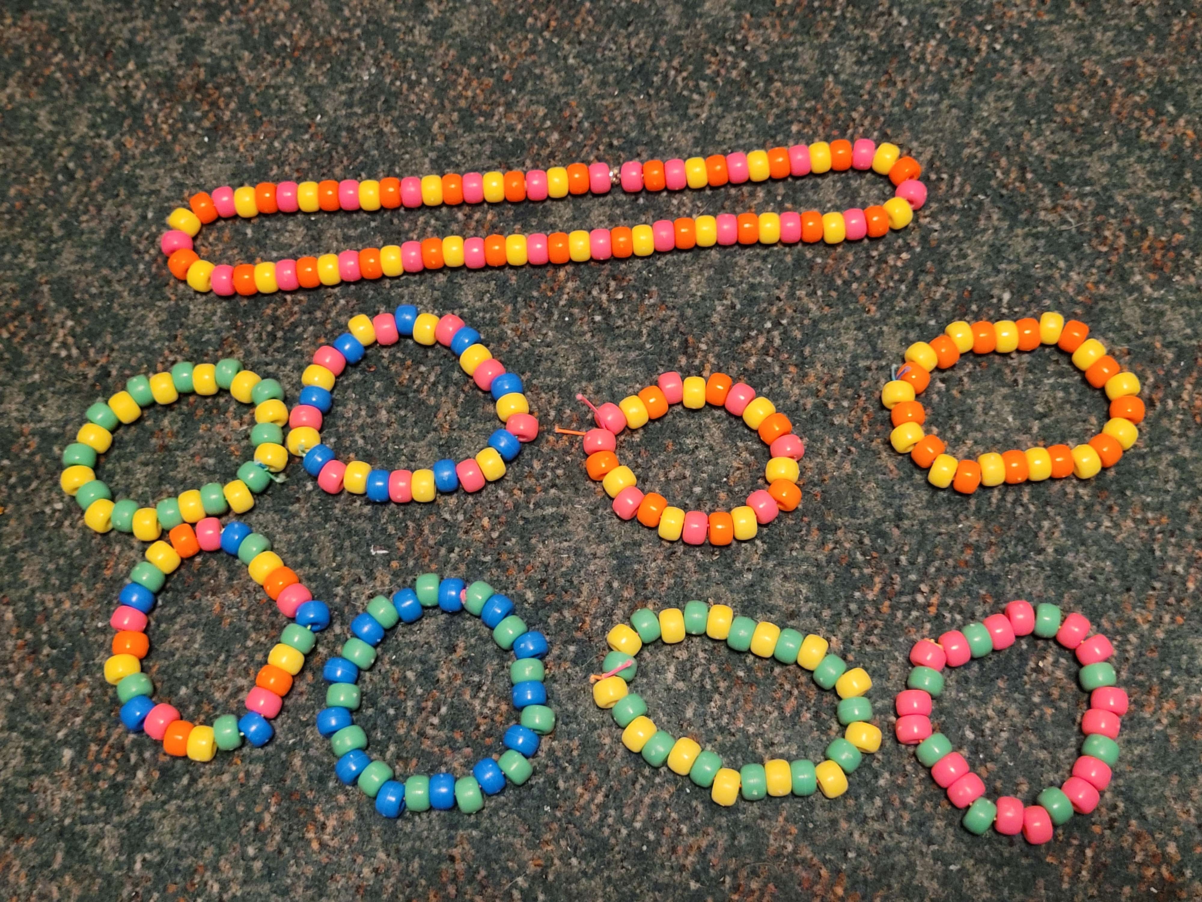 A set of various single beaded bracelets, with a variety of colors.