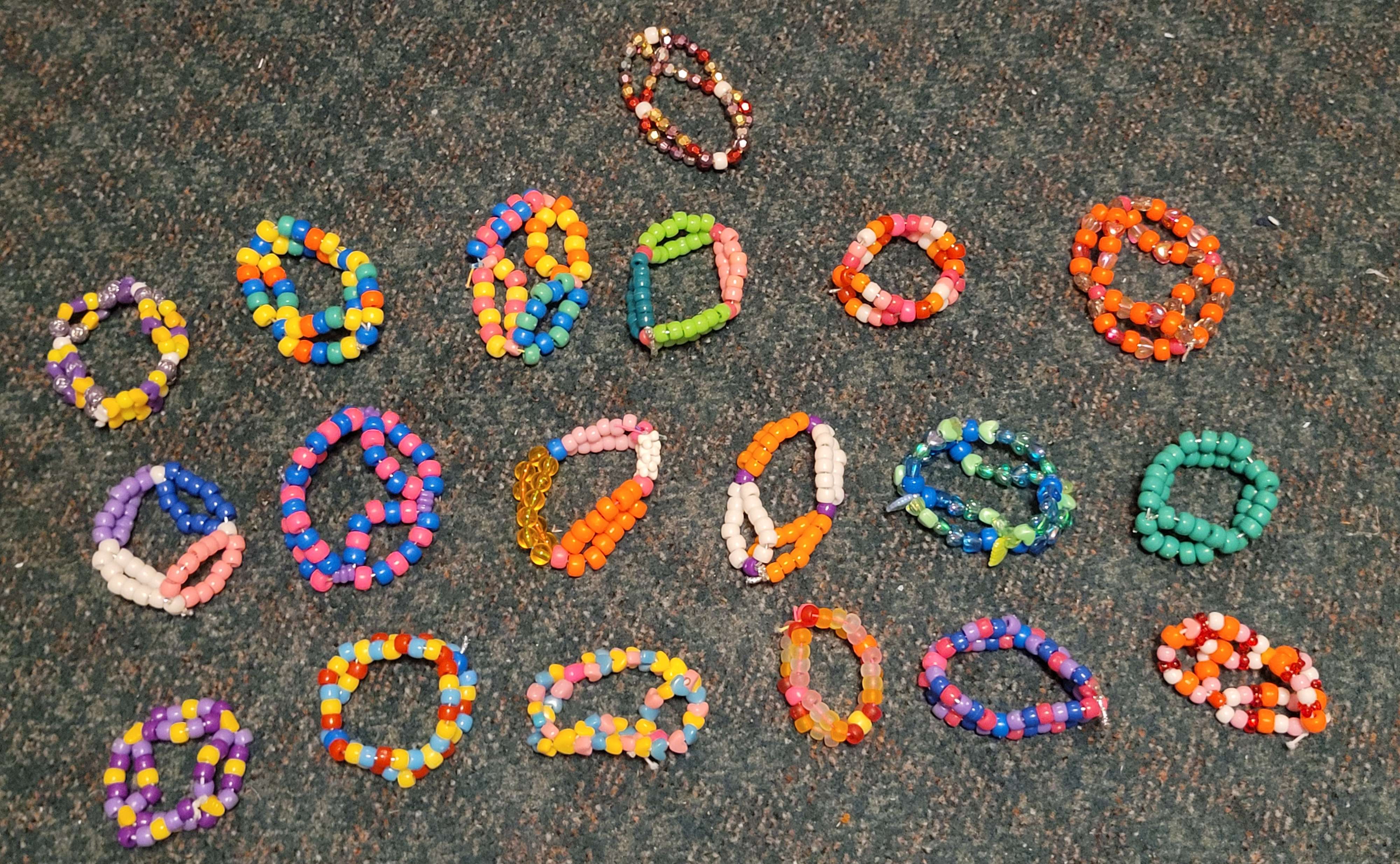 An organized pile of double beaded bracelets, made with a variety of colors.