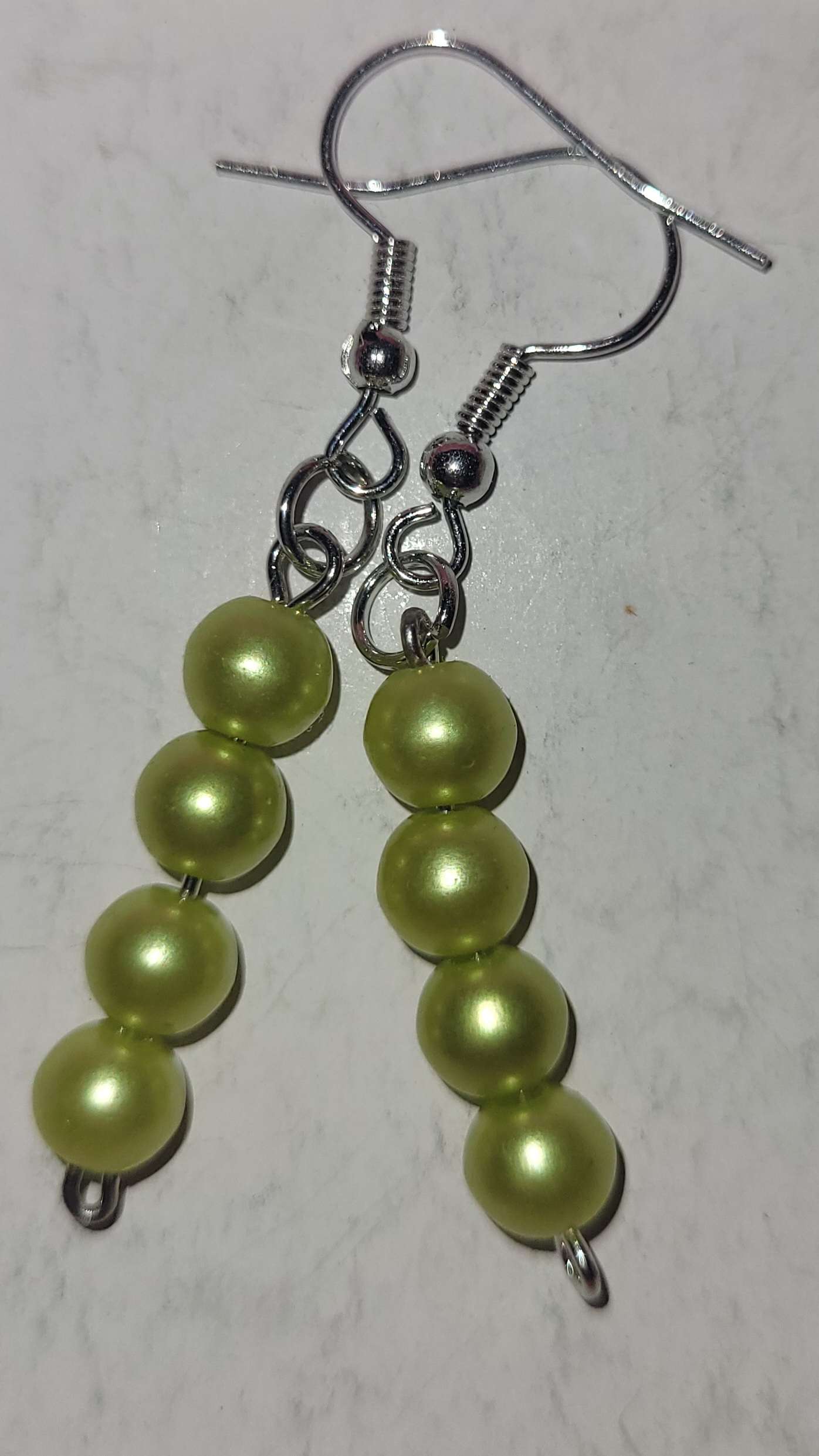 Earrings made with shiny green beads