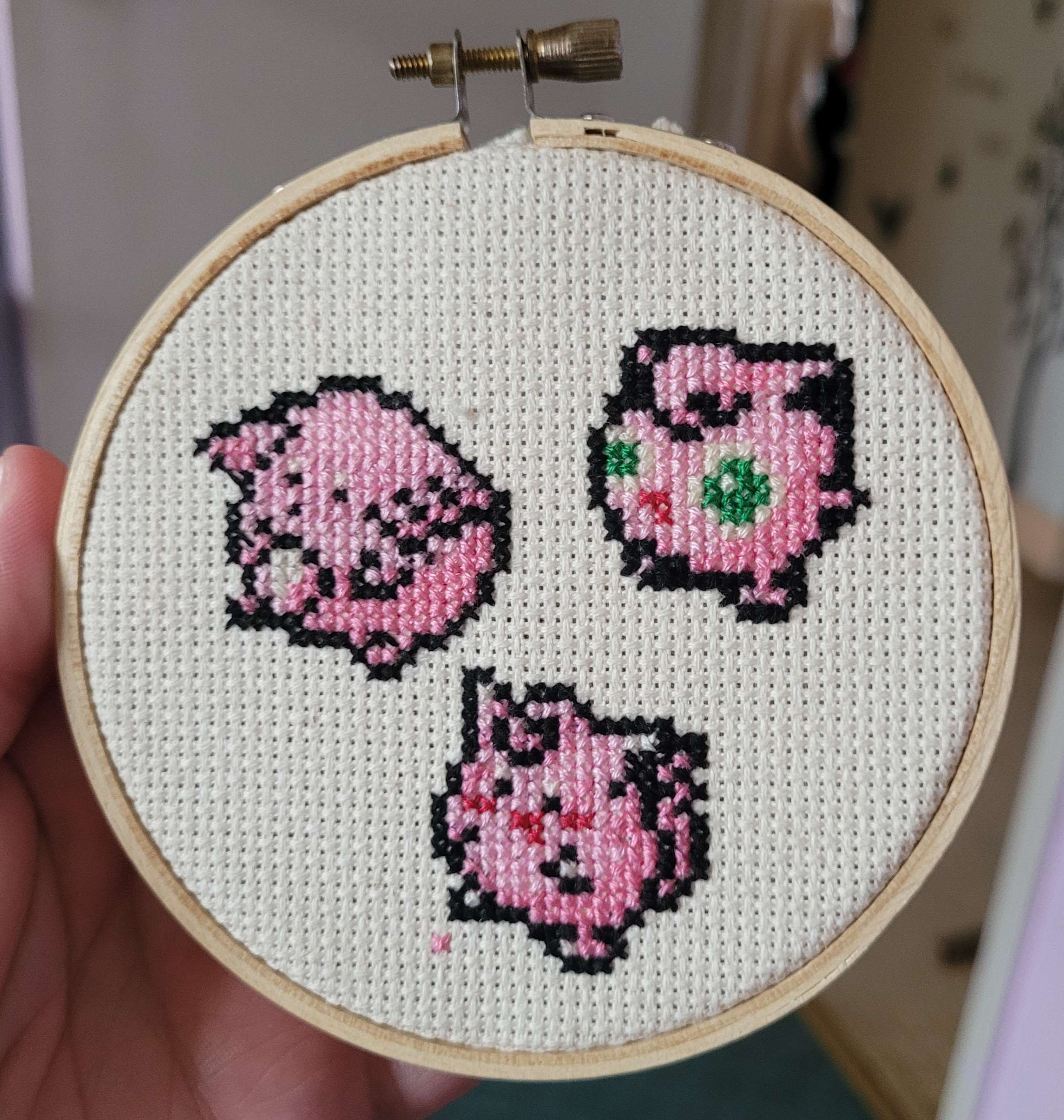 A cross stitch of chansey, clefairy, and jigglypuff from pokemon