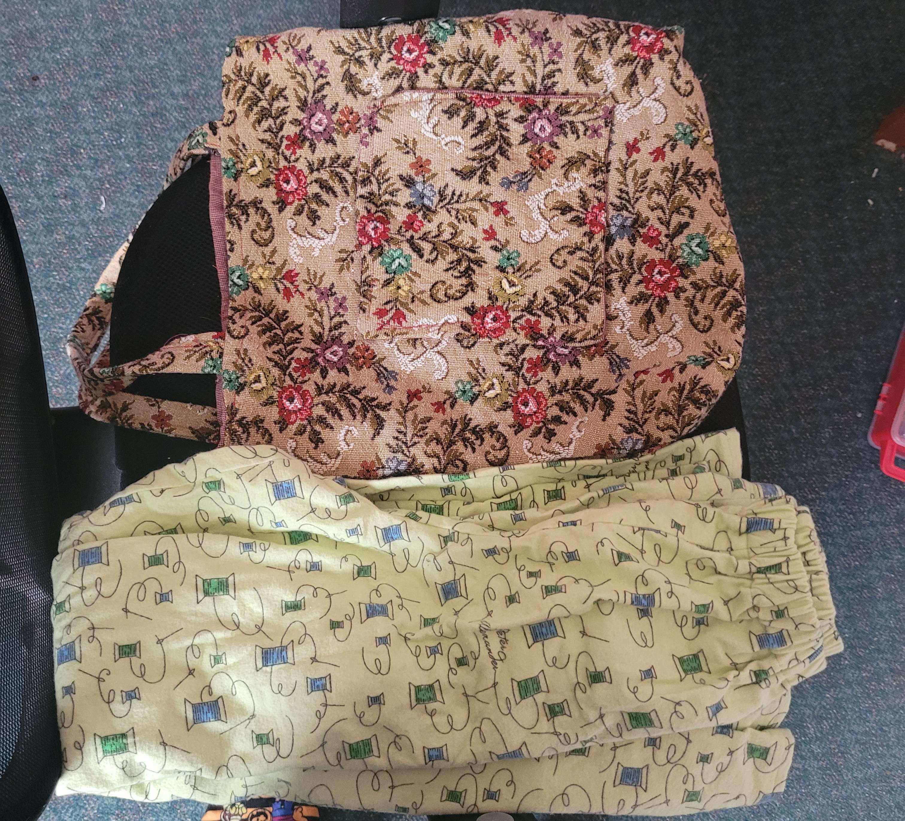 A tapestry tote bag and a pair of light green pajama pants.