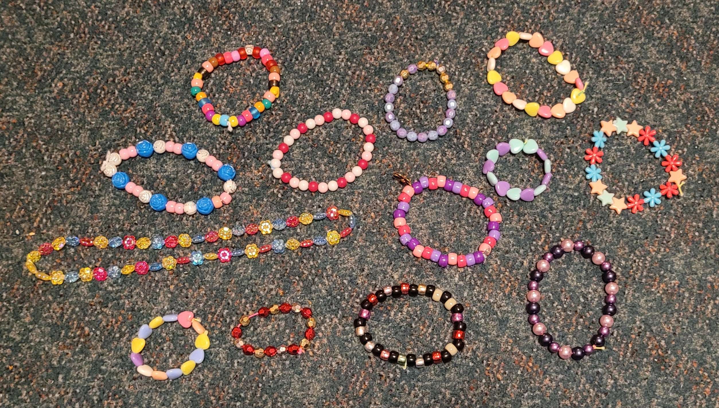 A pile of colored single beaded bracelets.